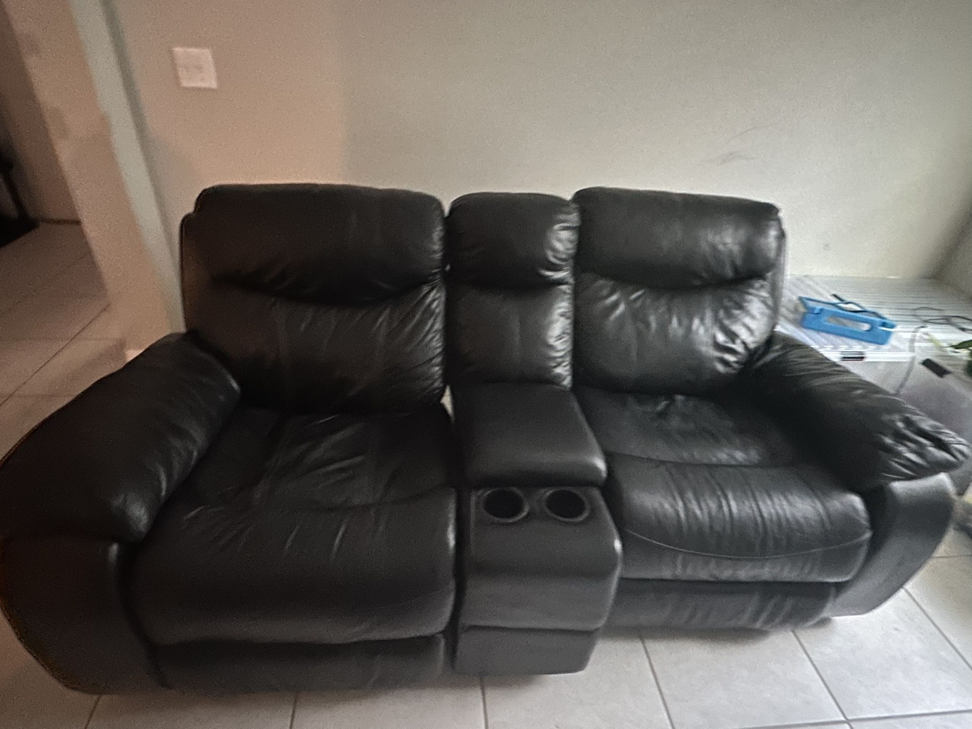 Black Leather Electric Couch and black Manual Rocking Loveseat