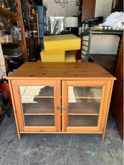 Newer IKEA Leksvik TV cabinet is crafted from solid pine and  two gl