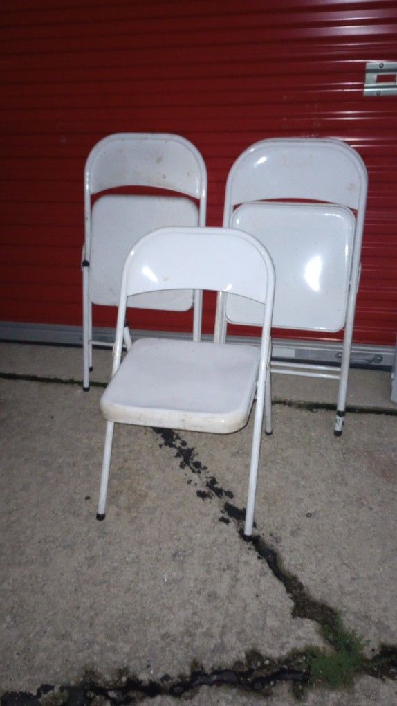 Three White Metal Folding Chairs