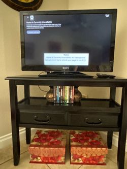 Black, 2-drawer, 3 ft x 13-inch TV stand and 32-inch Sony TV.