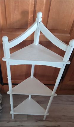 White vintage wooden corner shelf.
Sturdy and really cute!