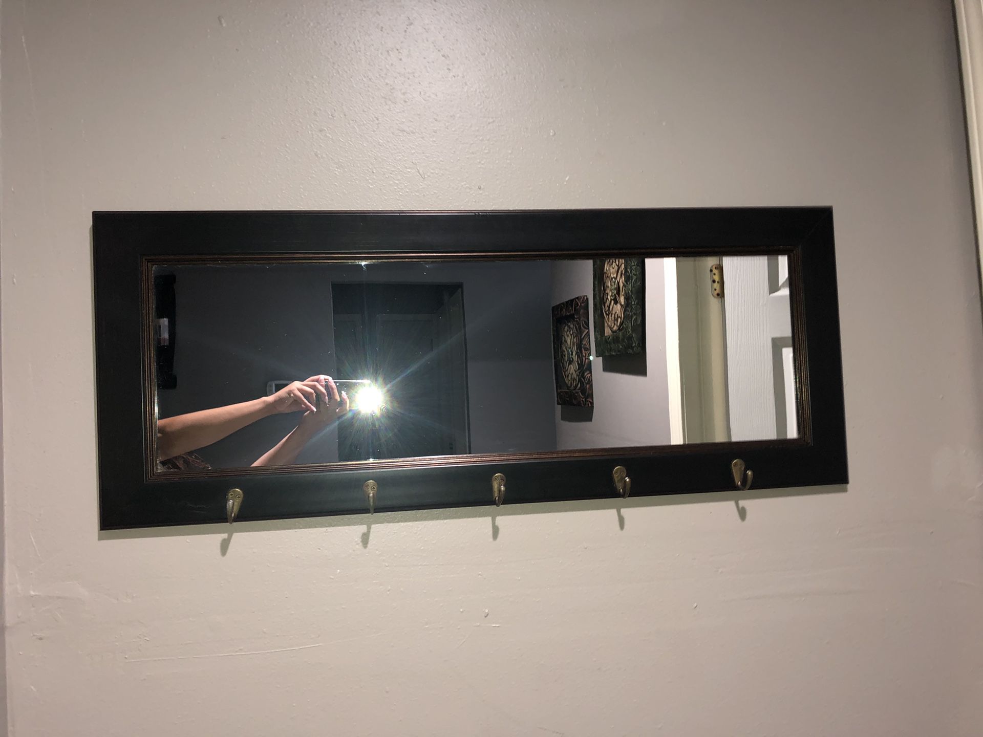 Wall mirror with hooks