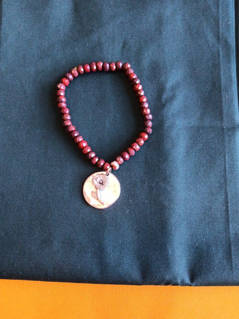 8 inch Dark Brown Stone Bracelet with a Rose Charm. (Back of Charm reads GROWTH).