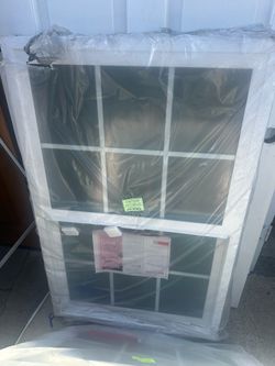 Window brand new still in the plastic  With grids vinyl double glass  Height 46.5 inches  Width 30 inches