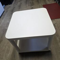 IKEA TINGBY white side table with wheelsVersatile IKEA TINGBY side table. White color. Has a handy bottom shelf for storage. 