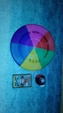 Multi-colored frisbee, small leather ball and playing cards with pirate on it.