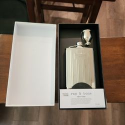 New in box Rag & Bone New York 7.6 fl oz silver-tone metal flask, 
It comes with a portable funnel for easy pouring, lightweight stainless steel, 