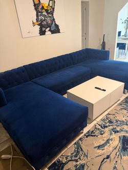 Blue sectional and two rotating chairs