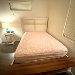 Farmhouse style solid wood queen-size bed with storage drawers. 