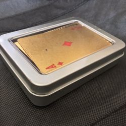 gold colored playing cards with $ theme 