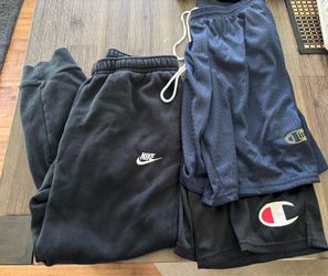 Black Nike jogger sweats and two pairs Champion shorts, size men’s medium