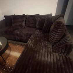 Chocolate brown beautiful sectional with glass end tables and coffee tables