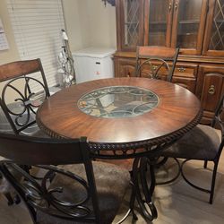 Small, round dining room table with 4 chairs