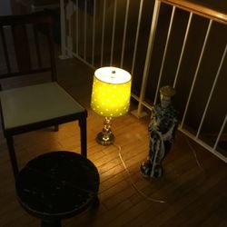 A Nice Ikea Lamp , An Old Fashioned , Vintage , Folding  Chair ,an Asian Lady, An Asian Stool Just Gorgeous 