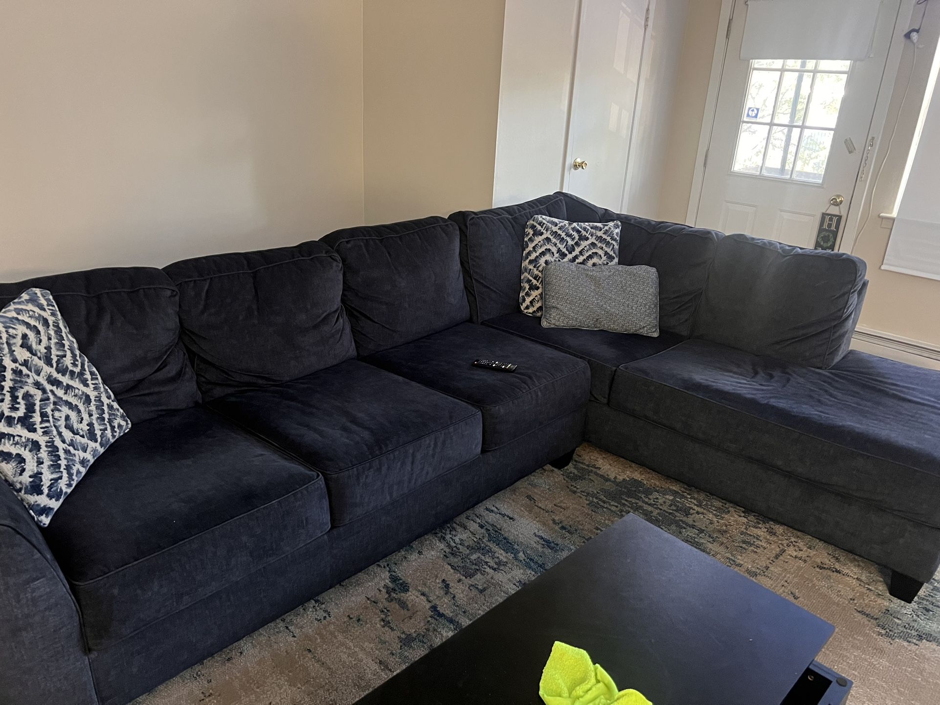 navy blue L shape coach