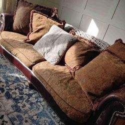 Brown leather couch with fabric cushions in good condition 