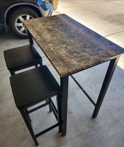 Bar table with 2 black bar stools