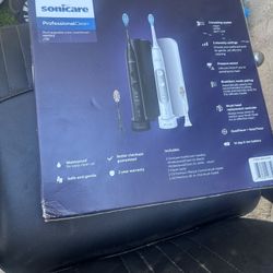 Pair of Philips Sonicare electric toothbrushes. Includes