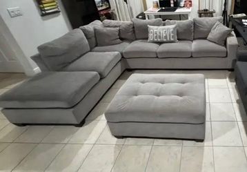 Grey sectional couch with ottoman