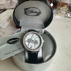 Disney Mother of Pearl -Mickey watch , black leather band , Cz all around bezel, this is a working watch with the box