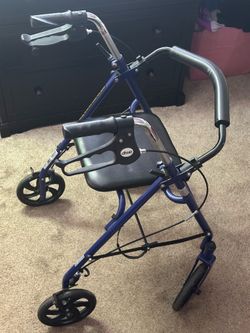 Drive Medical 4-Wheel Rollator Walker with a padded seat and a fold-up backrest