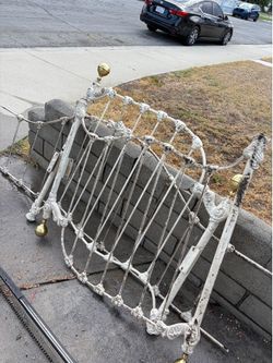 Antique wrought iron day bed frame with finials