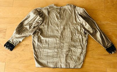 Gold top with lace cuffs and puffed shoulders, L/XL.