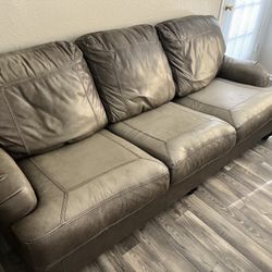 Gray leather couch and love seat