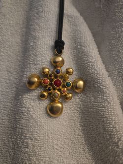 matte, satin, or hammered gold finish paired with smooth cabochon-cut stones (rounded, non-faceted gems).
