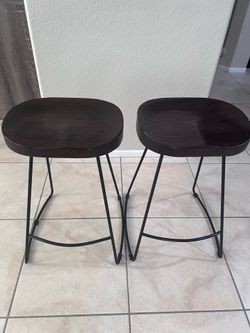 Two dark wood bar stools