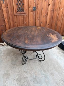 Solid wood round table - 54” in diameter - wrought iron base