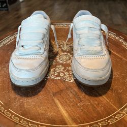All white classic Reebok shoes With A Gum Bottom