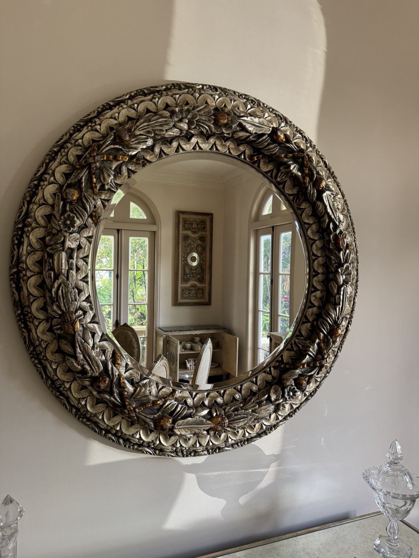 Large round ornate mirror featuring an antique silver & gold/bronze finish - 48”