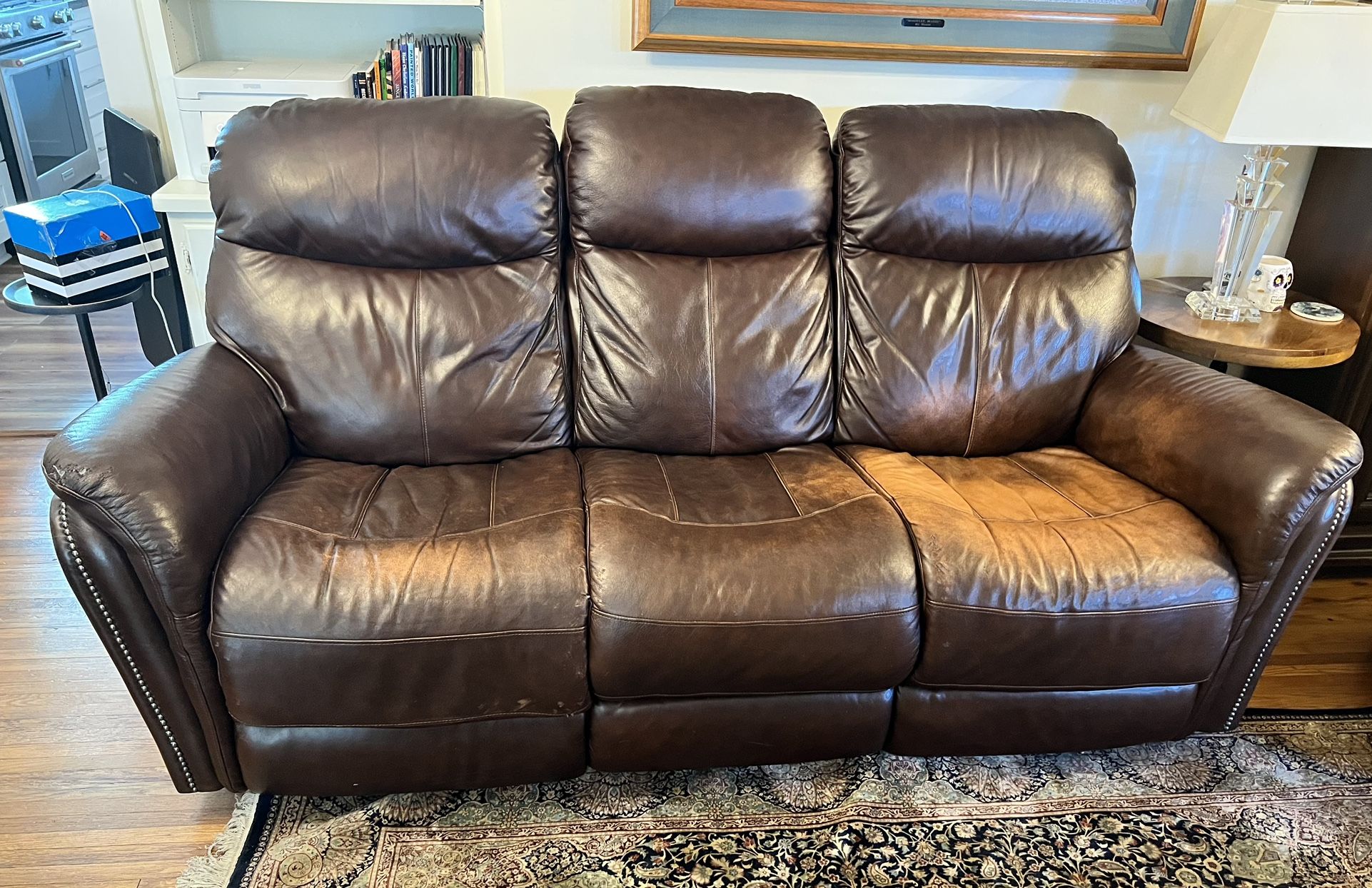 Comfortable brown leather reclining sofa in good condition. 