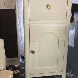 White bathroom storage cabinet.