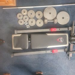 Bench with bar and weights with 20lb dumbell