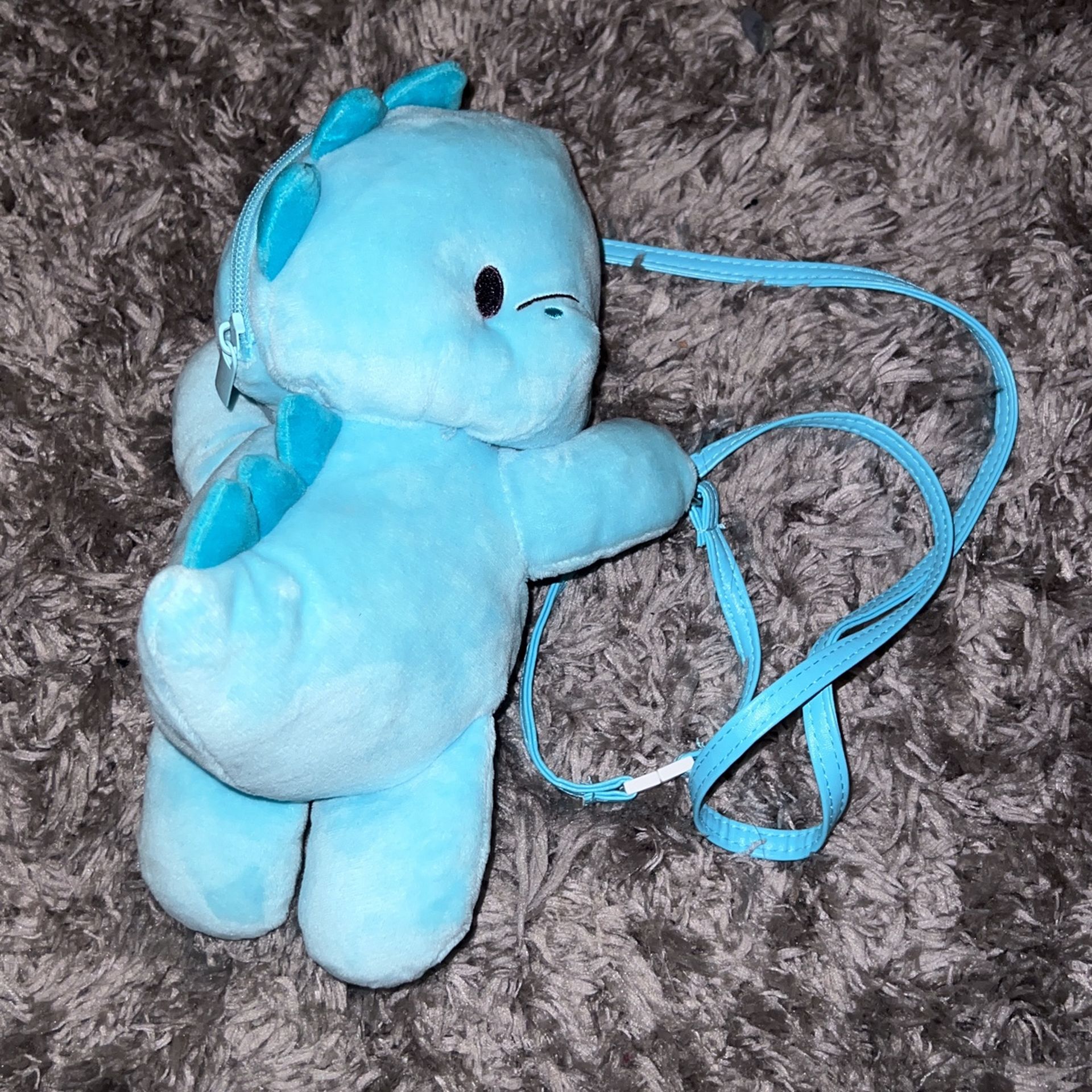 Small blue dinosaur plush backpack