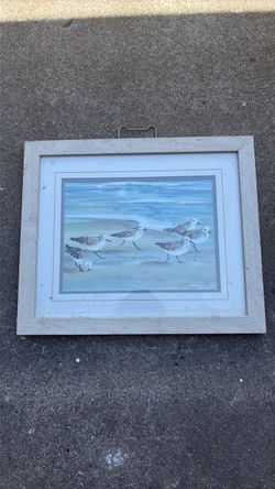 Bird painting beach sand
