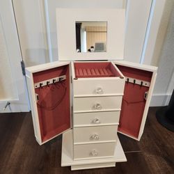 Standing jewelry armoire 27" open  height( 19"closed), flip-top lid, four pull-out drawers, side-swing doors, Top Compartment, good condition