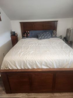 Wooden queen sized bed with storage