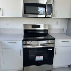 New stainless steel stove, refrigerator, microwave, and dishwasher