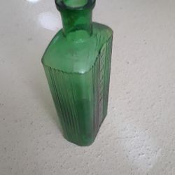 Vintage bottle. Very old green pharmacy bottle reads NOT TO BE TAKEN.  7 inchs tall. 