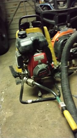 gas-powered backpack concrete vibrator, specifically identifying as a model powered by a Honda GXH50 4-stroke engine.
