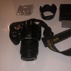Nikon D3100  Digital camera  and holder with Charger and Extra battery works great no problem 