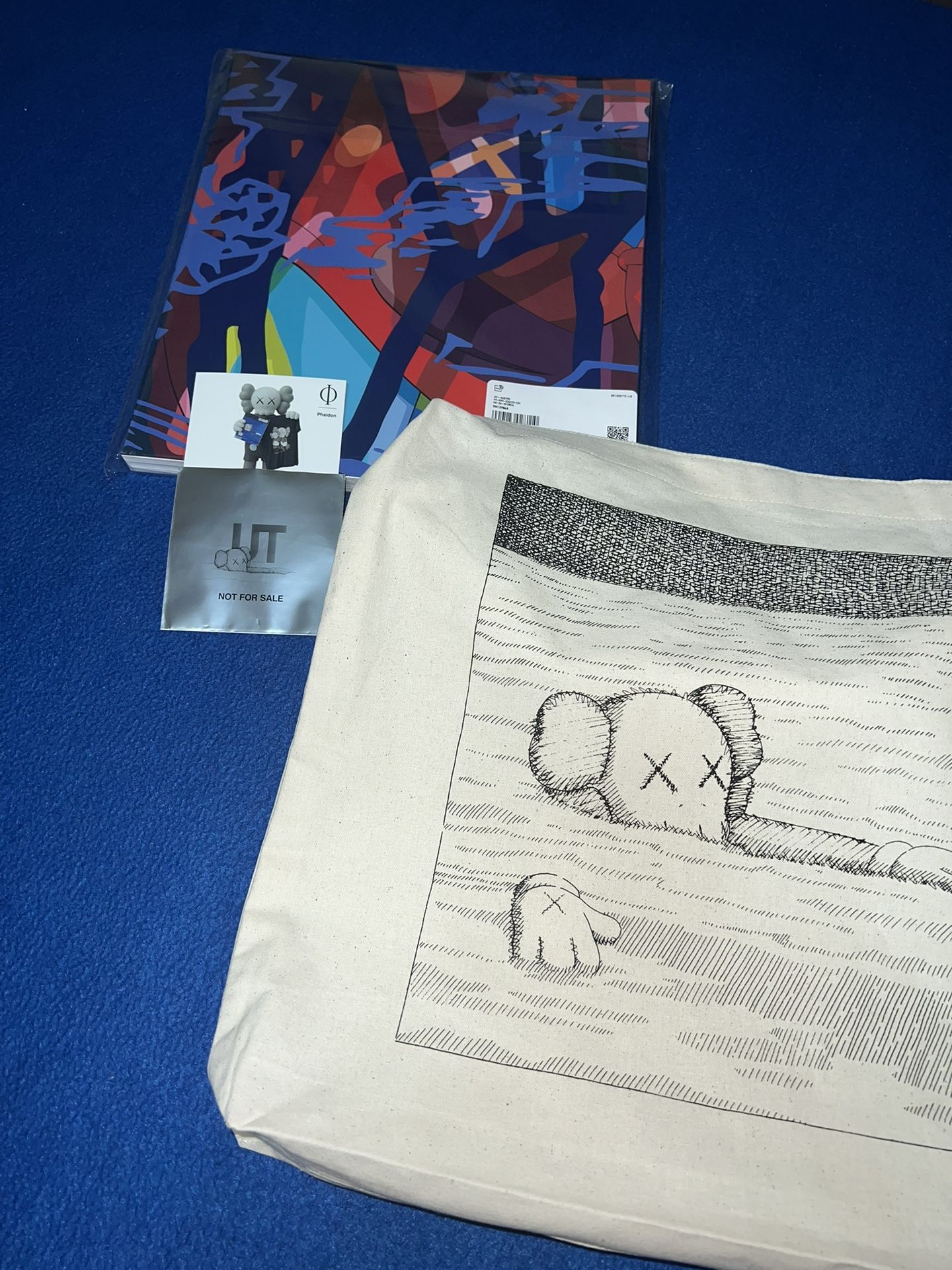 Kaws x Uniqlo Collaboration Art Book with a tote bag and stick a bundle