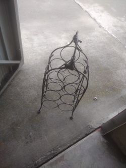 Metal Wine Rack Holds Seven Bottles