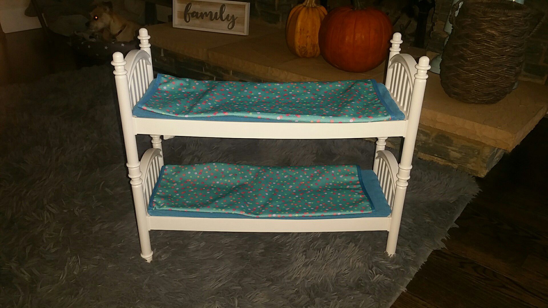 Doll bunk beds with little mattress and sheets.