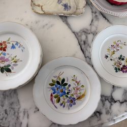 Vintage porcelain salad plates with scalloped rims and a hand-painted floral design