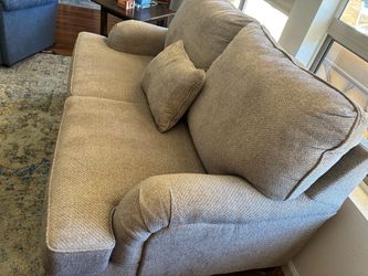 Oatmeal beige loveseat.  Dimensions 66” width x 37” height x 34” deep.