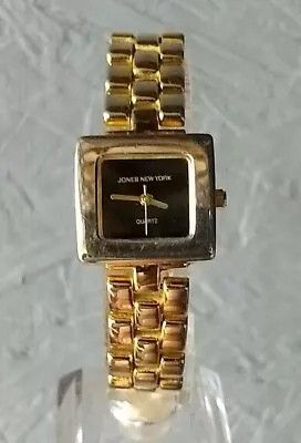 Jones New York ladies watch gold tone with black dial.